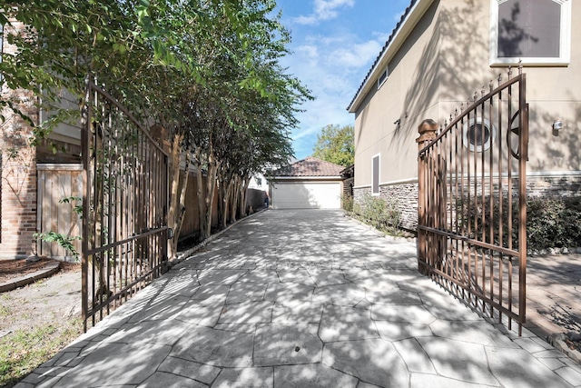 view of property exterior featuring an outdoor structure and a garage