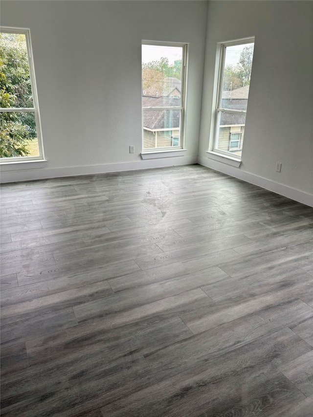 unfurnished room with dark hardwood / wood-style floors