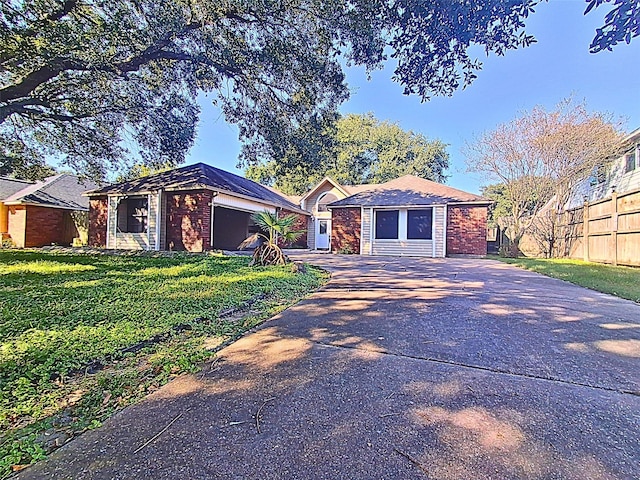 ranch-style home with a front lawn