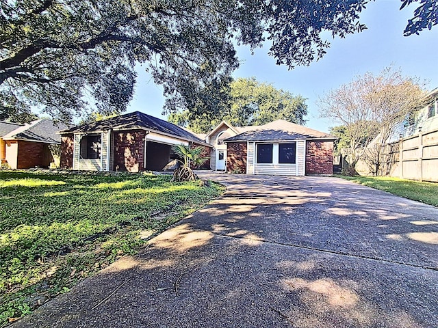 single story home with a garage and a front yard