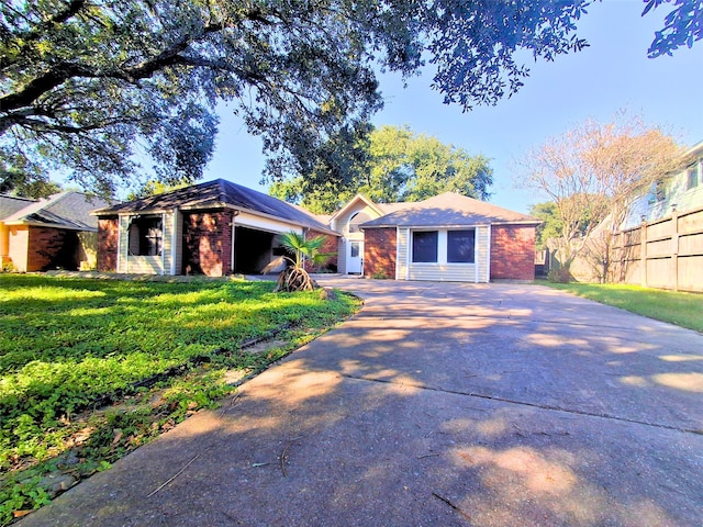 single story home with a front yard and a garage