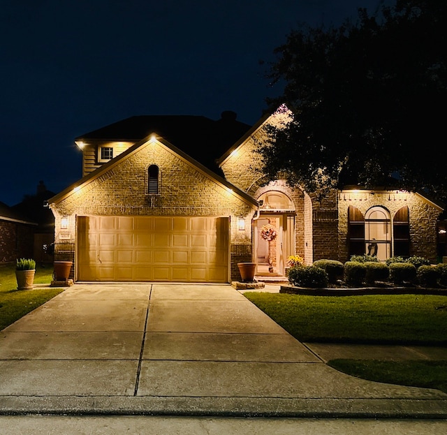 view of front of home with a lawn and a garage