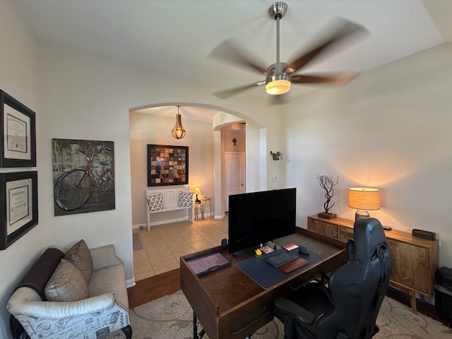 home office with ceiling fan and light wood-type flooring