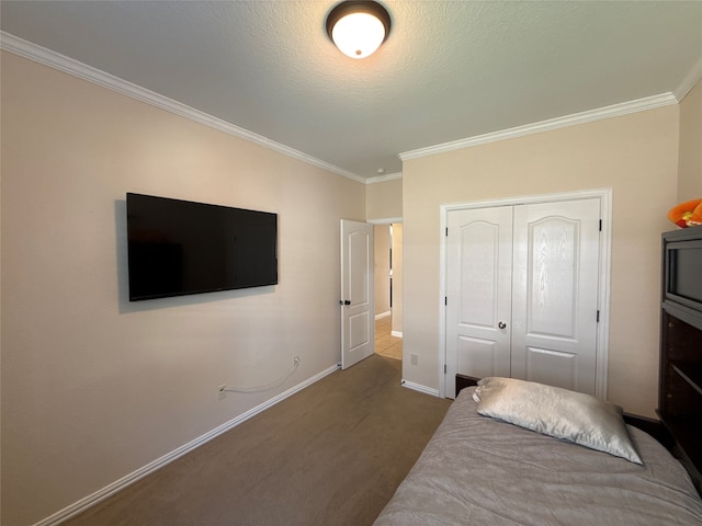 carpeted bedroom with a closet, a textured ceiling, and ornamental molding