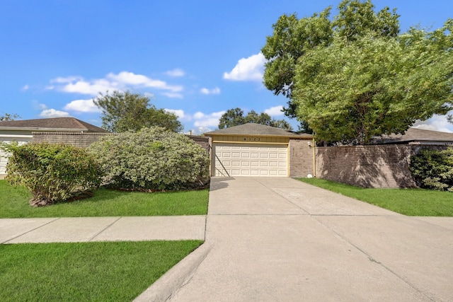 view of front of property featuring a front yard and a garage