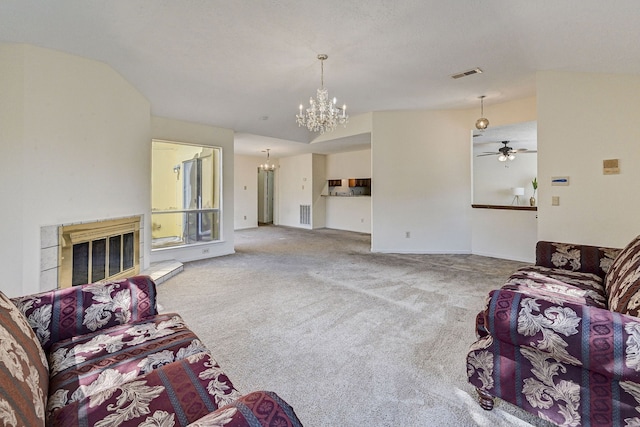 carpeted living room with ceiling fan with notable chandelier