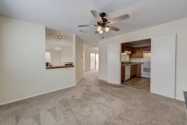 unfurnished living room featuring a textured ceiling, sink, light colored carpet, and ceiling fan with notable chandelier