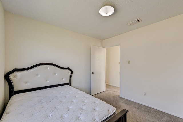 unfurnished bedroom with light colored carpet and a textured ceiling