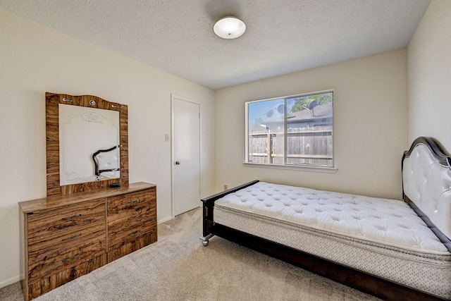 bedroom with carpet and a textured ceiling