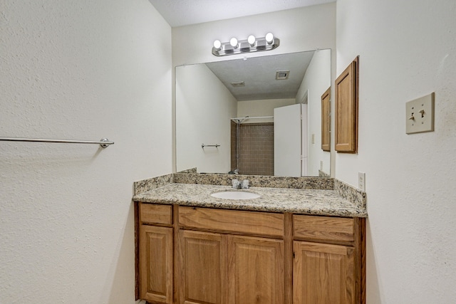 bathroom featuring vanity and a textured ceiling