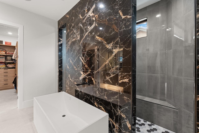 bathroom with tile patterned flooring, a shower, and tile walls