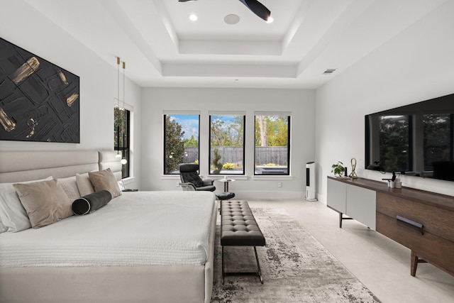 bedroom with a raised ceiling and ceiling fan