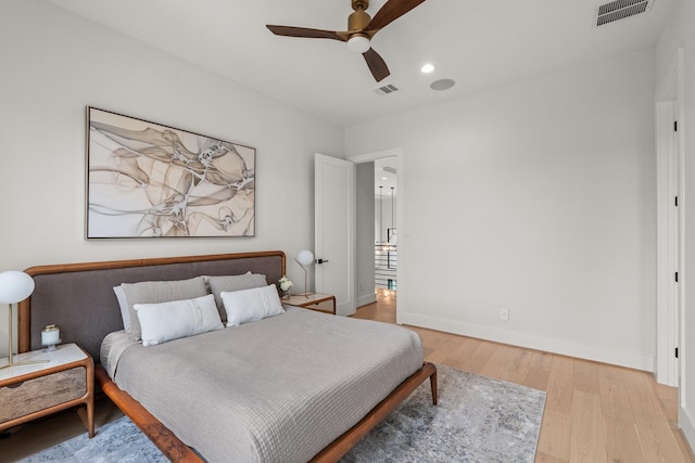 bedroom with ceiling fan and light wood-type flooring