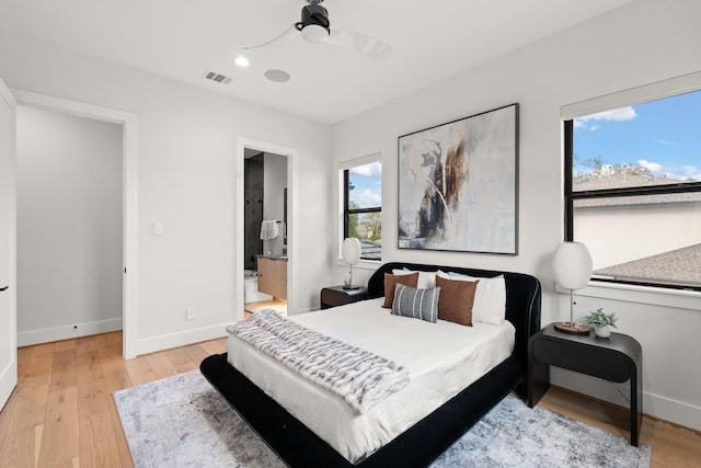 bedroom featuring ceiling fan, ensuite bathroom, and light hardwood / wood-style floors