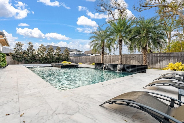 view of pool featuring pool water feature and a patio