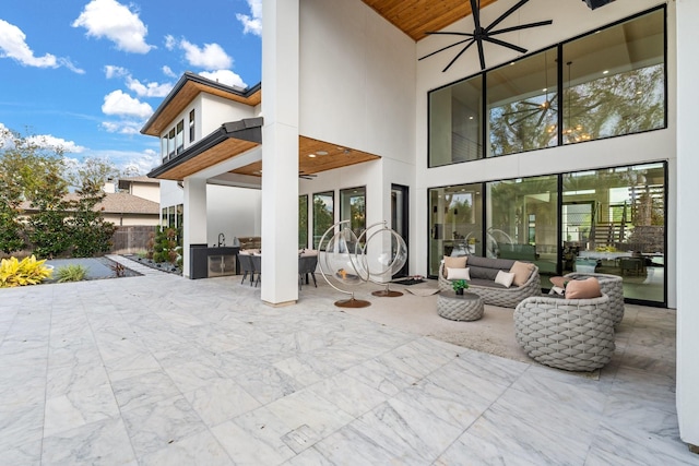 view of patio / terrace with an outdoor living space, ceiling fan, and exterior kitchen