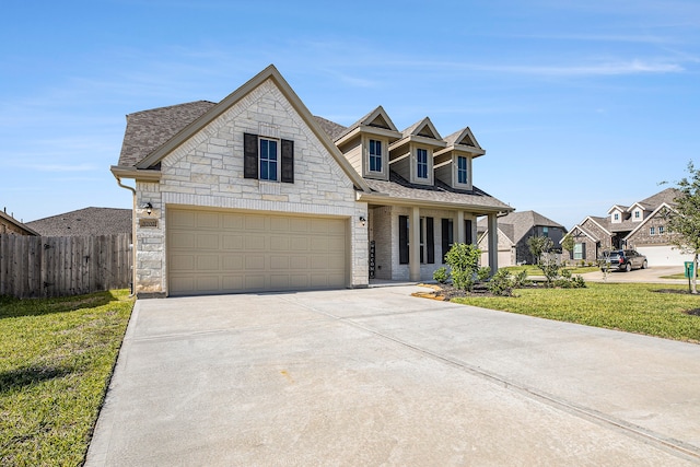 view of front of property with a front yard and a garage