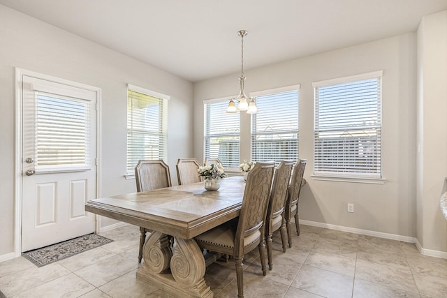 dining space with light tile patterned floors and a chandelier