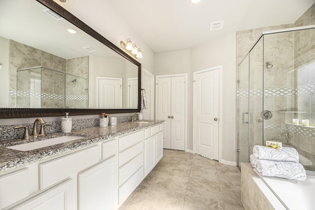 bathroom featuring vanity and a shower with door