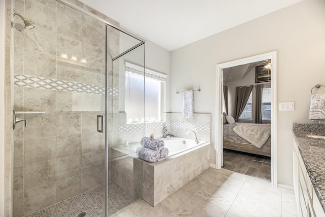 bathroom featuring shower with separate bathtub and vanity