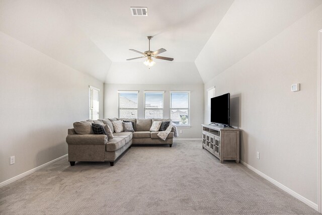 carpeted living room with ceiling fan and lofted ceiling