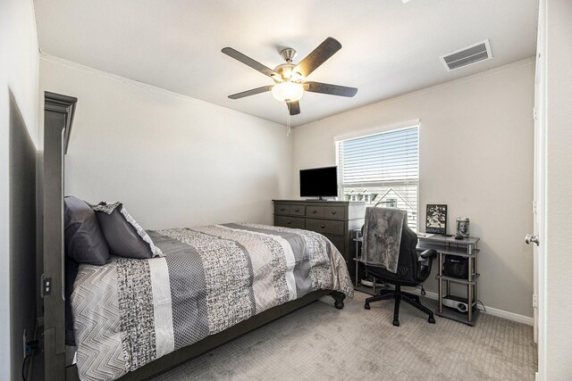 bedroom featuring ceiling fan, carpet floors, and ornamental molding