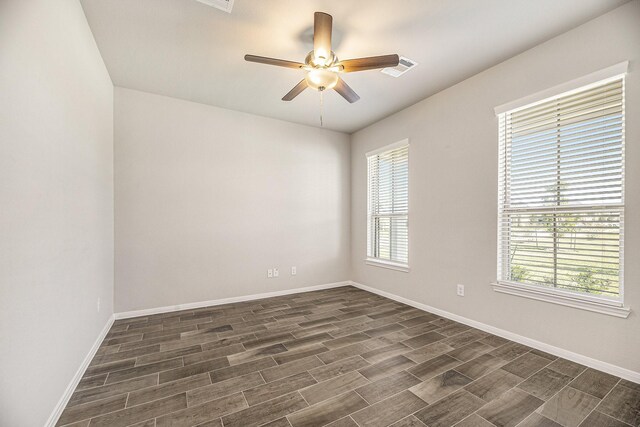 unfurnished room featuring ceiling fan, plenty of natural light, and dark hardwood / wood-style floors