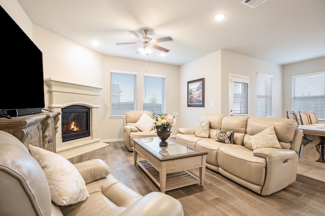 living room featuring wood-type flooring and ceiling fan