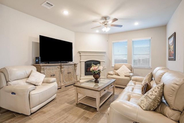 living room with ceiling fan and light wood-type flooring