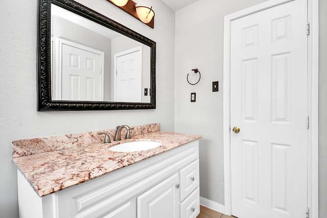 bathroom featuring tile patterned flooring and vanity