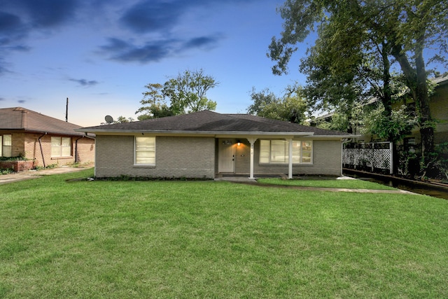 ranch-style home featuring a yard