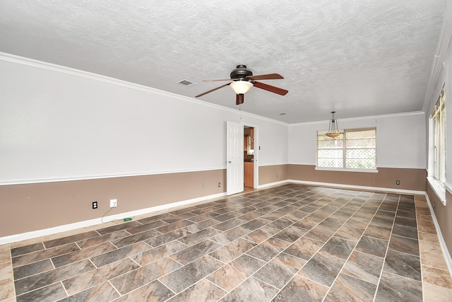 empty room featuring ceiling fan, crown molding, and a textured ceiling