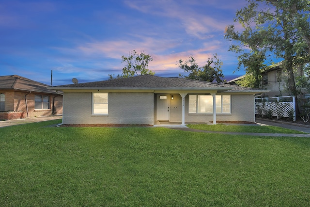 ranch-style house featuring a yard