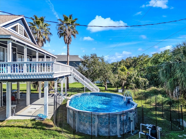 view of swimming pool with a lawn and a deck