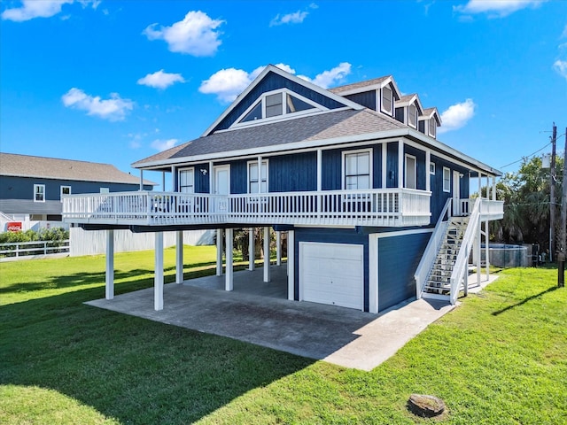 view of front of house featuring a front lawn, a deck, and a garage