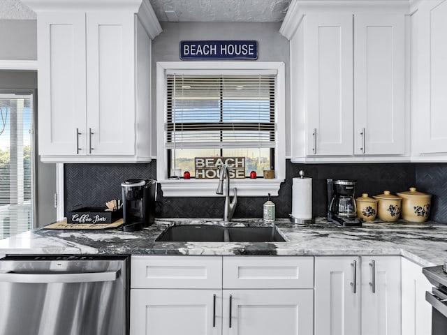 kitchen featuring sink, white cabinets, and stainless steel dishwasher