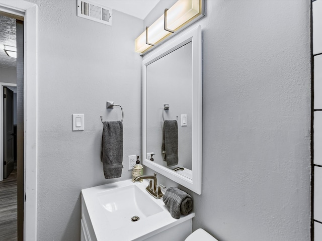 bathroom featuring hardwood / wood-style floors and vanity