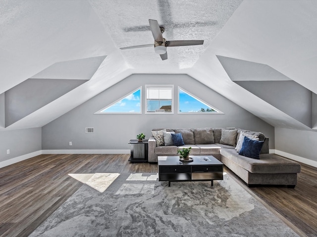 living room with hardwood / wood-style floors, a textured ceiling, and vaulted ceiling