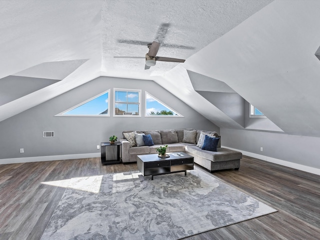 living room featuring a textured ceiling, dark hardwood / wood-style flooring, ceiling fan, and lofted ceiling