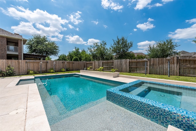 view of swimming pool with an in ground hot tub