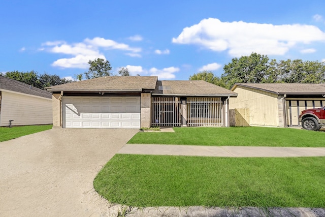 single story home featuring a garage and a front yard