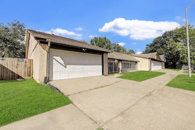 ranch-style home with a front yard and a garage