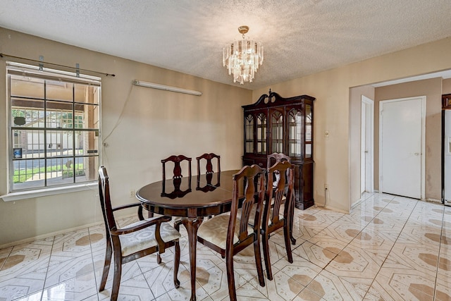 tiled dining space with a textured ceiling and a notable chandelier