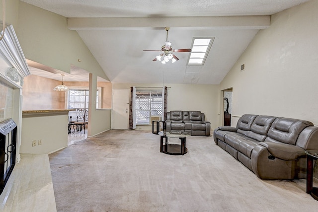 carpeted living room with beam ceiling, a tile fireplace, ceiling fan, and high vaulted ceiling