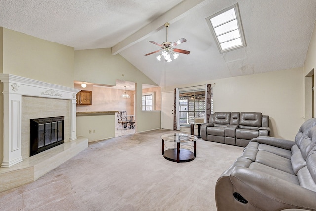 carpeted living room featuring a high end fireplace, high vaulted ceiling, ceiling fan, a textured ceiling, and beam ceiling