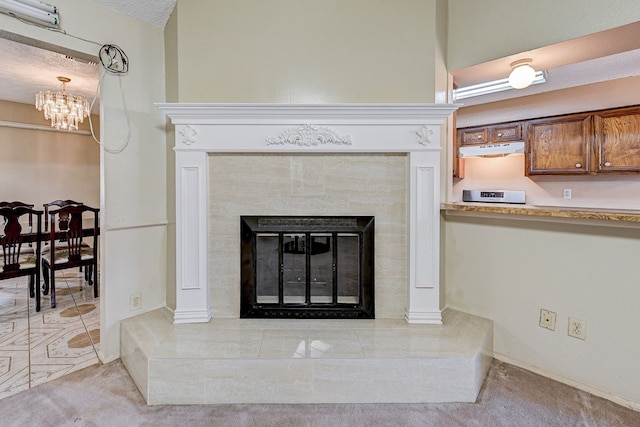 details featuring a fireplace, a textured ceiling, carpet floors, and white range oven