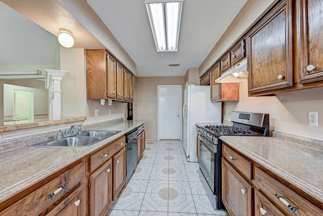 kitchen featuring sink, black dishwasher, stainless steel gas range, a textured ceiling, and light tile patterned flooring