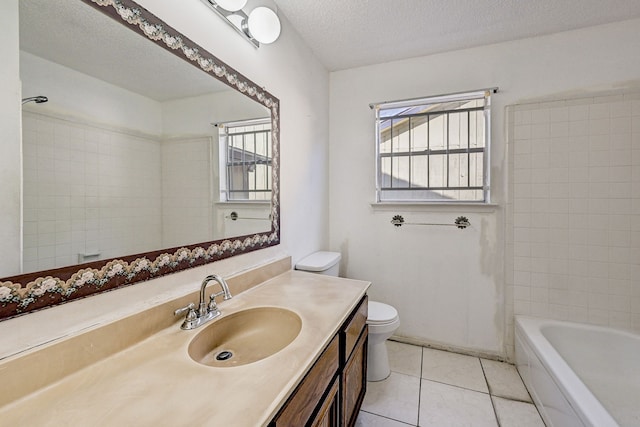 full bathroom with tile patterned floors, a textured ceiling, vanity, toilet, and tiled shower / bath