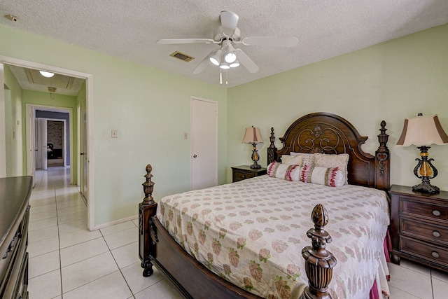 tiled bedroom featuring ceiling fan and a textured ceiling