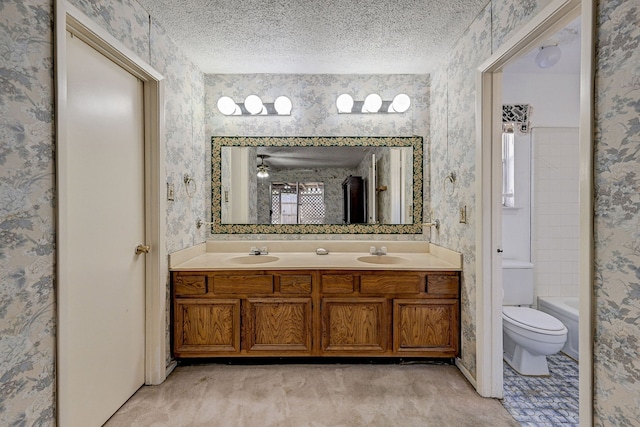 bathroom featuring vanity, a textured ceiling, and toilet